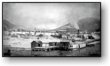 Panorama of dock with a steam boat in the background.